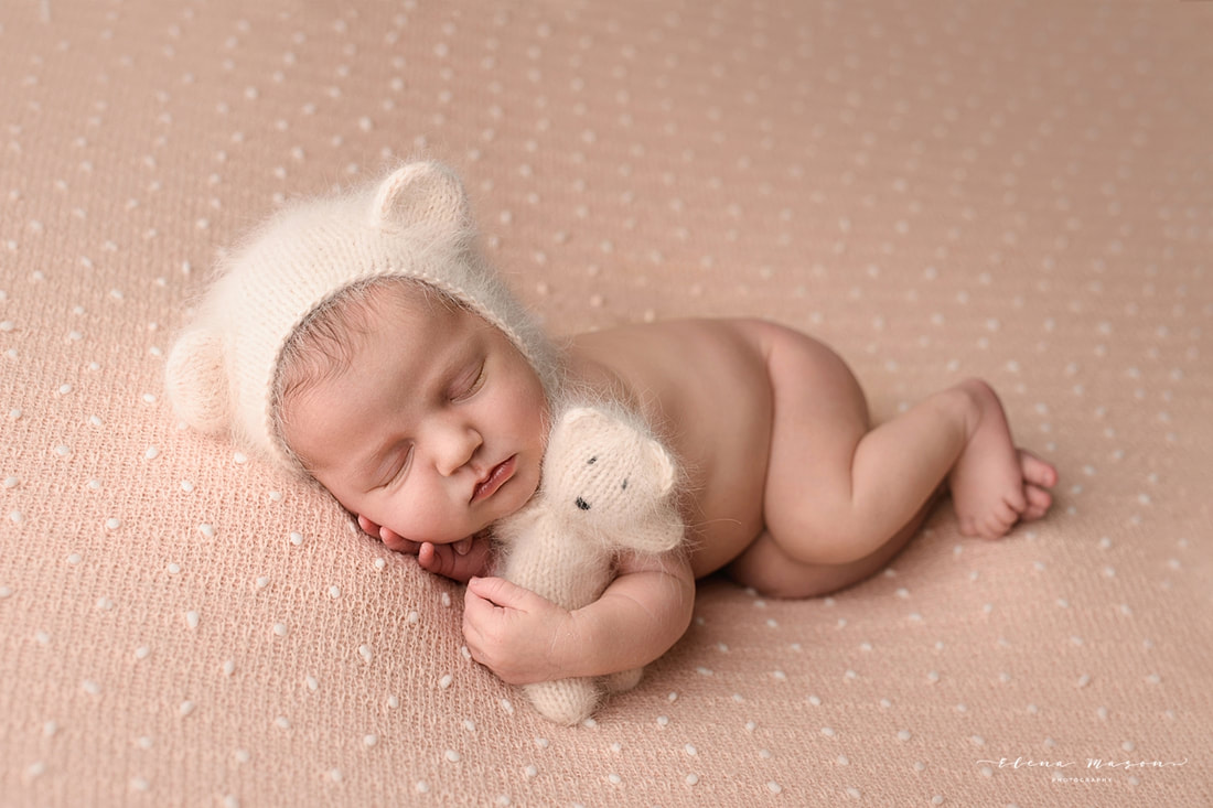 baby in bear hat with a bear